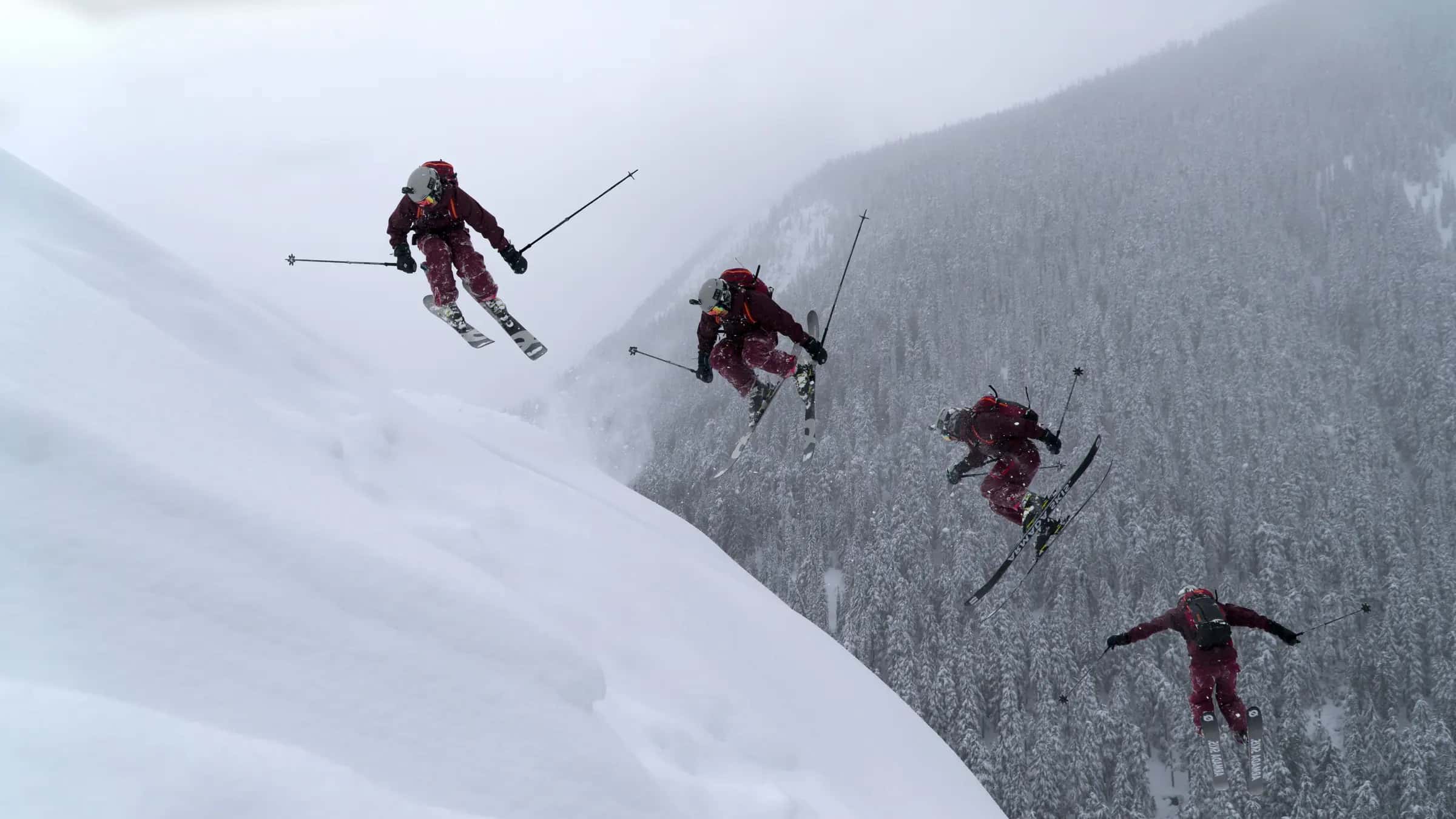 A skier performs a thrilling jump off a snowy mountainside, showcasing extreme winter sports.