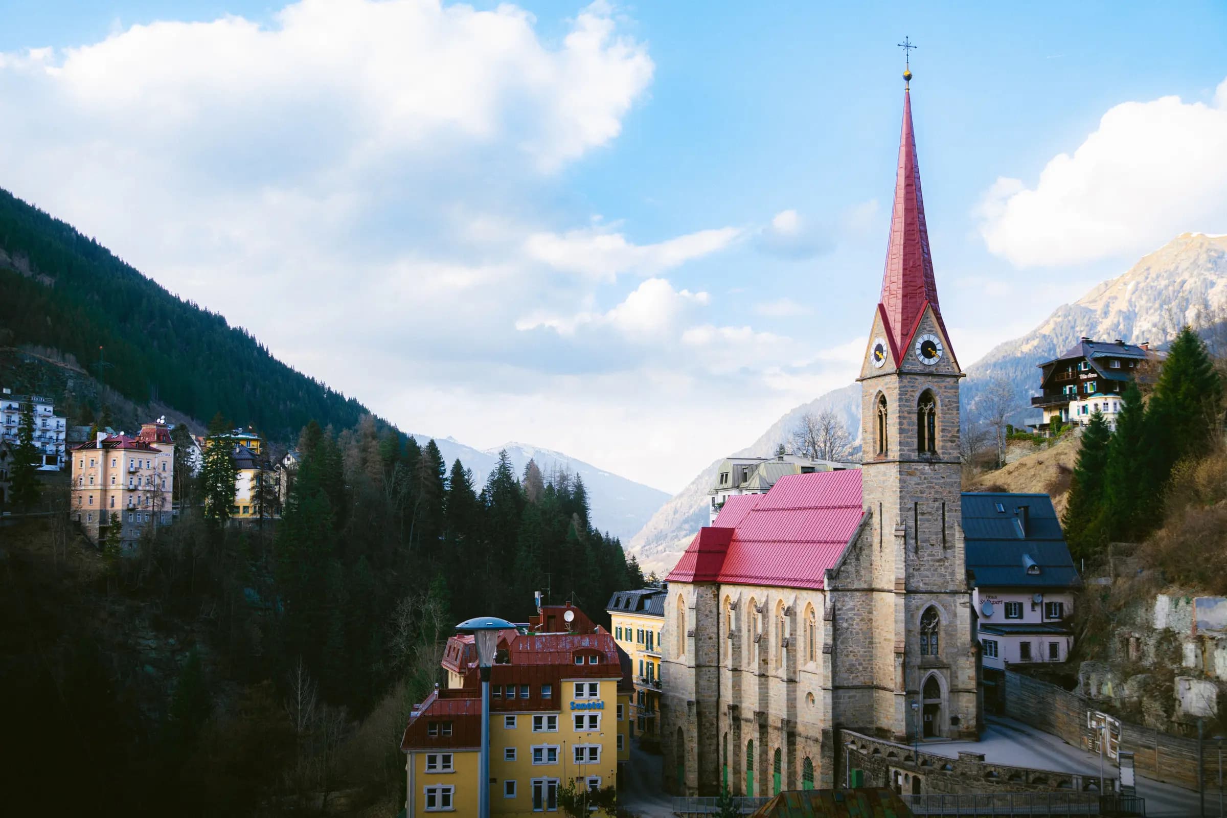 A picturesque church and buildings nestled in the alpine town of Bad Gastein, Austria.