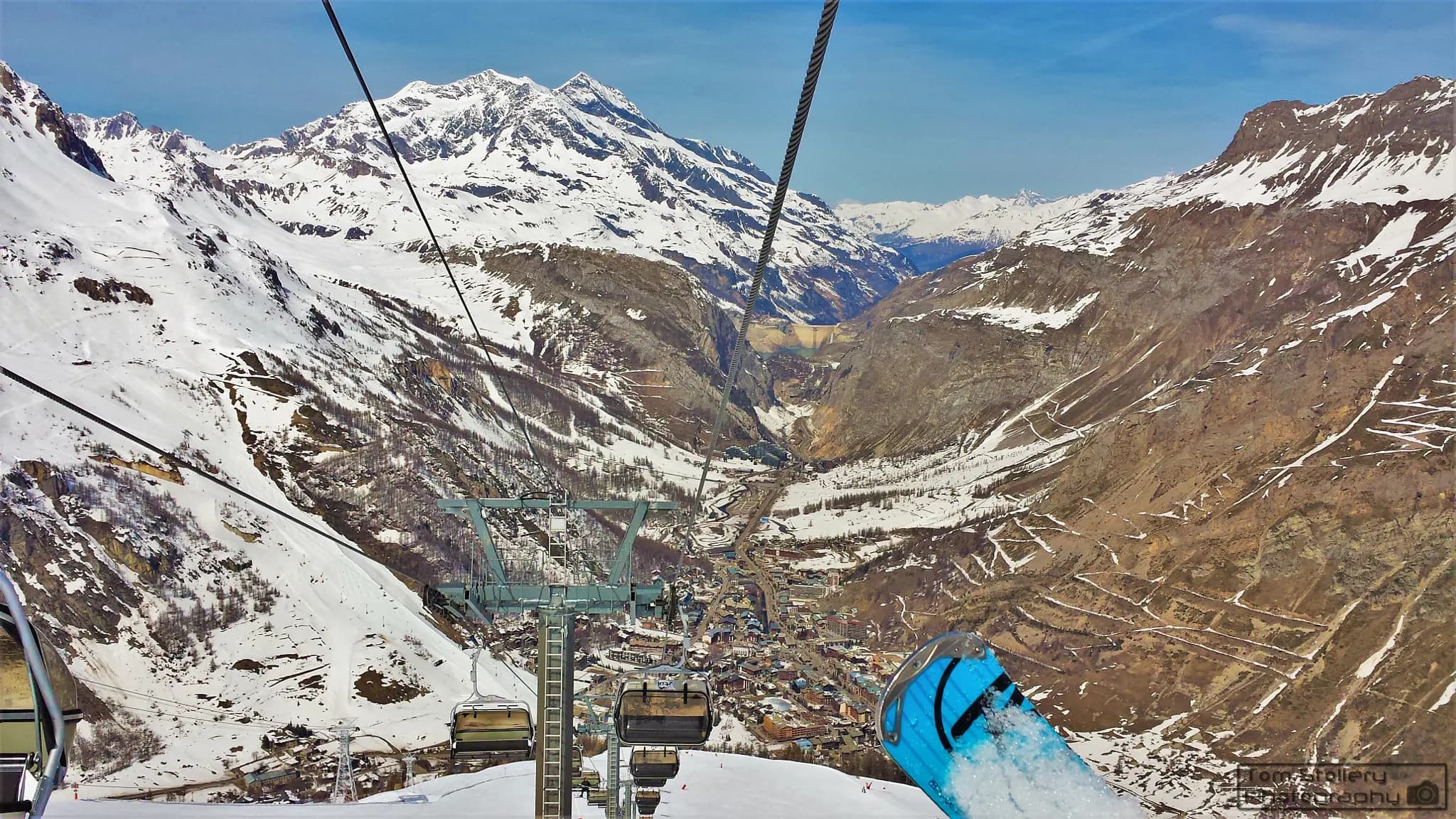 500px provided description: Looking down at Val D'Isere and the valley all the way to Tignes Dam in the Tarentaise Valley, French Alps. [#Landscape ,#Snow ,#Rocks ,#Travel ,#Winter ,#Holiday ,#France ,#Cold ,#Lake ,#Mountains ,#French ,#Alps ,#Skiing ,#Ski ,#Ice ,#Scenery ,#Town ,#Blue sky ,#Dam ,#Peaks ,#Snowboarding ,#Glacier Valley ,#Val D'Isere ,#Tarentaise Valley]