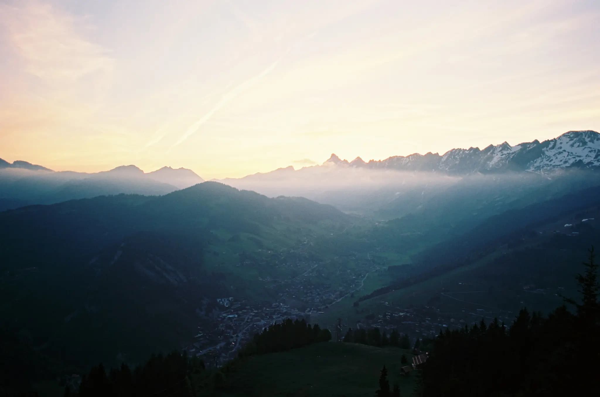 500px provided description: With my friend K?vin Brenguier, we decided to wake up before the sunrise and go gatch the sun rising on the top of a mountain at La Clusaz in the french Alps. We hicked all the way up to a closed restaurant. The actual valley we chose in a ski station during the winter. Taken in La Clusaz, Haute-Savoie, France. Spring 2015. Shot with Minolta SRT101 loaded with Kodak Ekta 100. [#trees ,#sunrise ,#morning ,#forest ,#mountains ,#spring ,#nature ,#sun ,#film ,#natural ,#minolta ,#france ,#35mm ,#woods ,#dawn ,#alps ,#outdoors ,#french ,#moutains ,#beginning ,#argentique ,#film camera ,#golden hours ,#pellicule ,#firstlight ,#believeinfilm ,#2015 ,#Analog ,#La Clusaz ,#Kodak Ektar 100 ,#Haute Savoie ,#Film photography ,#justgoshoot ,#shotonfilm ,#letsgosomewhere ,#SRT 101 ,#keepexploring ,#packandgo ,#explorecreate ,#skiing station ,#stayandwander ,#minolta SRT-101]