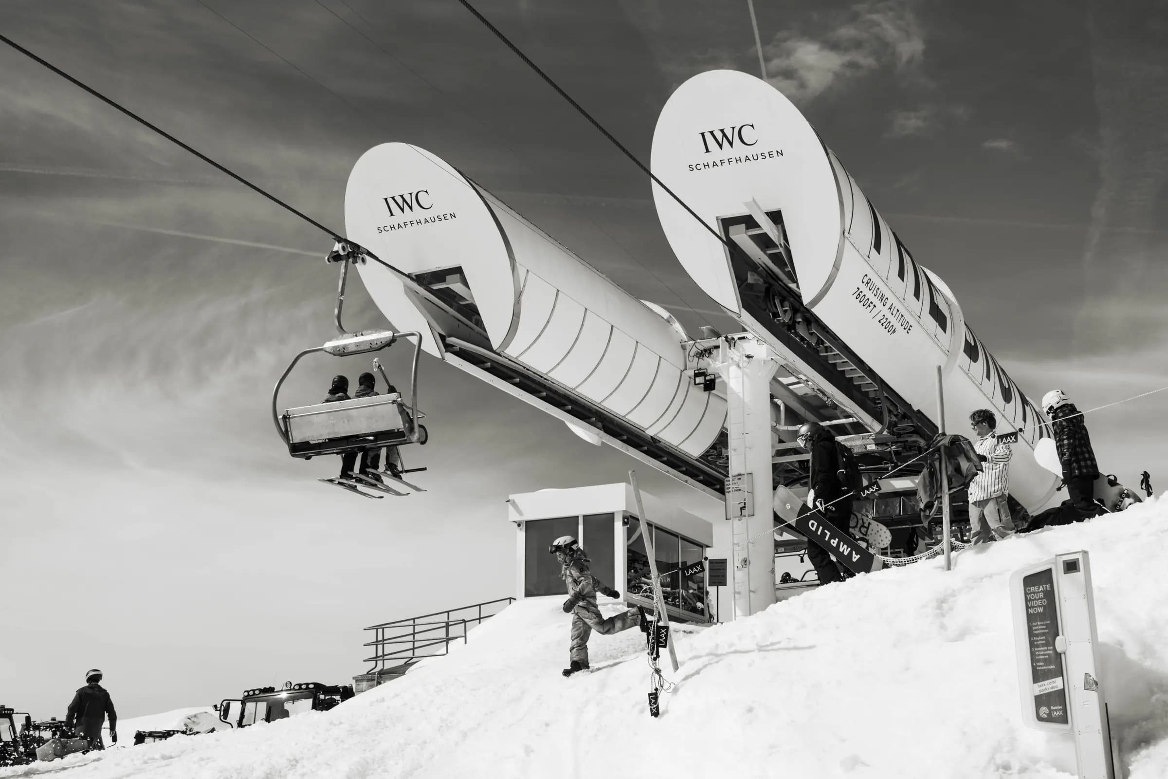 Black and white image of skiers on chairlift at Laax resort, Switzerland.