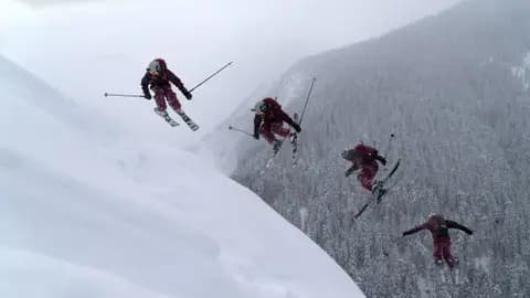 A skier performs a thrilling jump off a snowy mountainside, showcasing extreme winter sports.