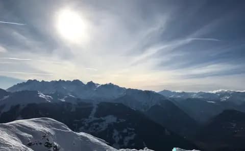 Looking West on the ski slopes into the Verbier valley during winter, with the mountains all around.
