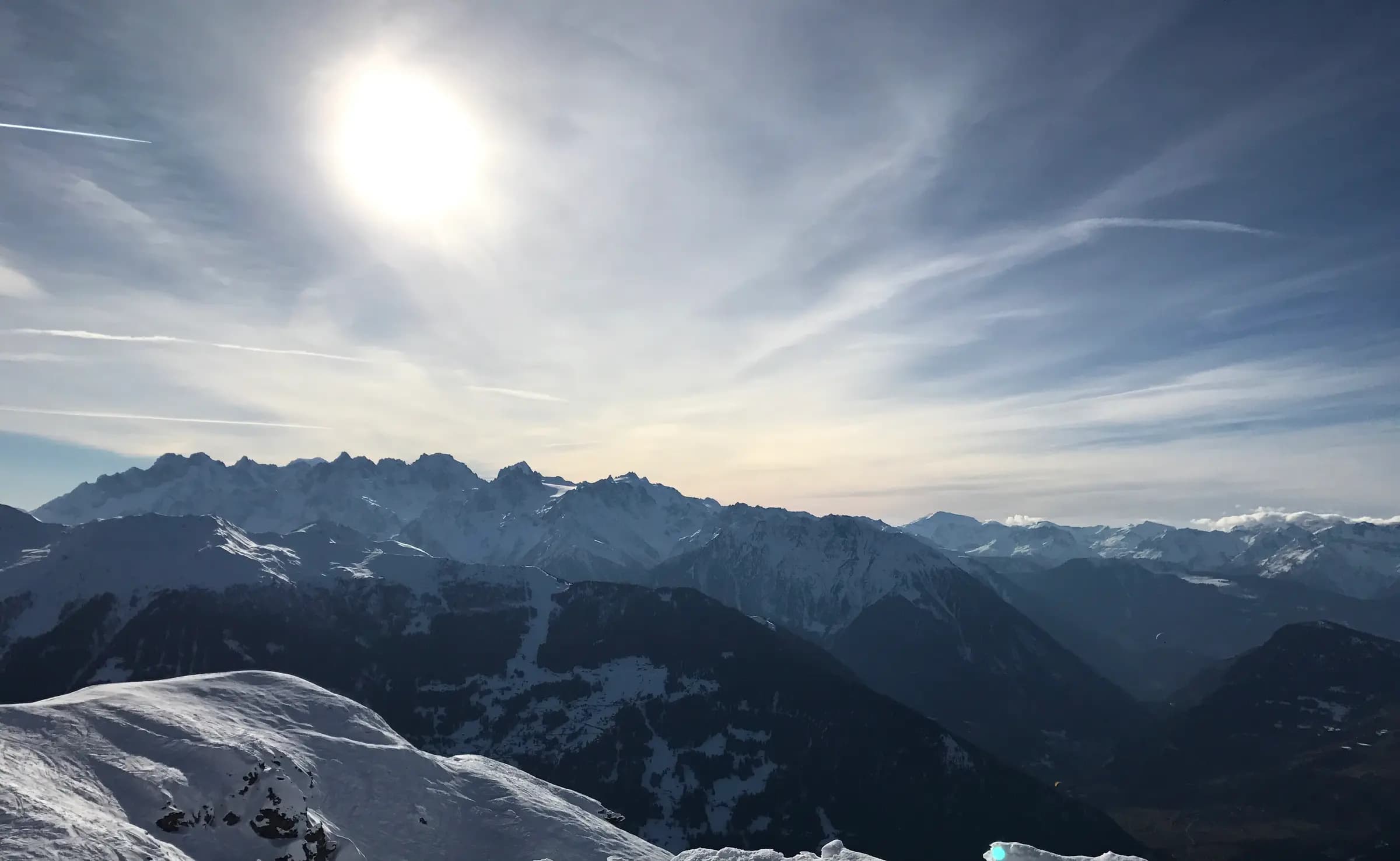 Looking West on the ski slopes into the Verbier valley during winter, with the mountains all around.