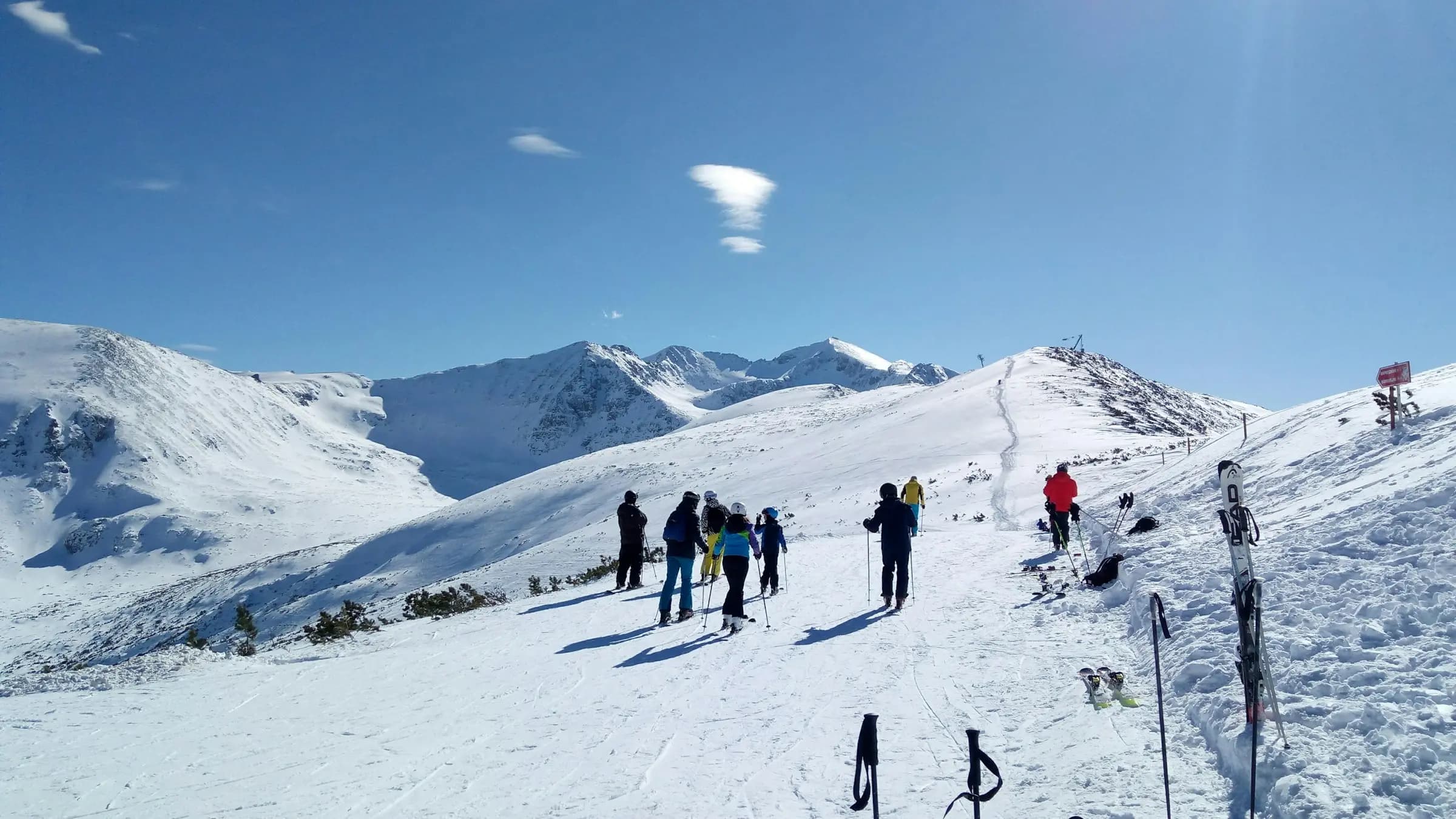 a group of people skiing down a snow covered slope