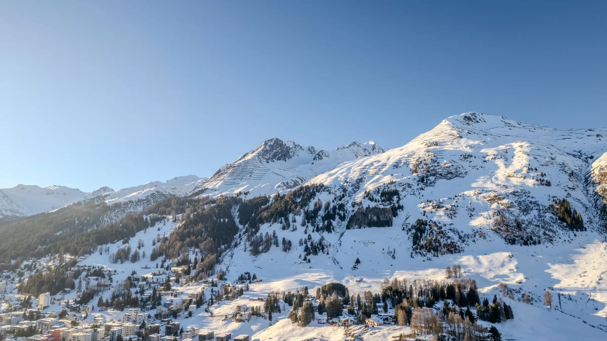 Breathtaking view of snow-covered mountains in Davos, Switzerland during winter.