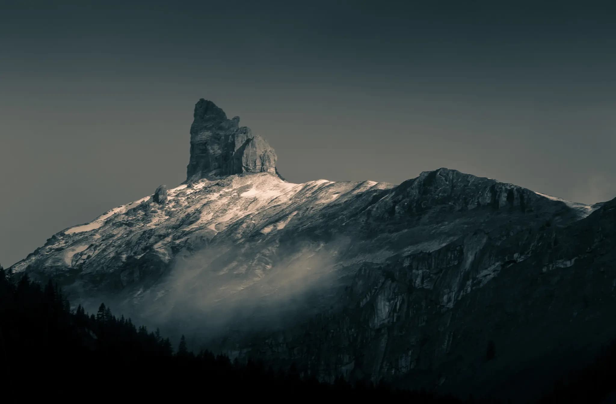 500px provided description: Early morning view of a distant peak from a viewpoint in Wengen, Switzerland. I've been searching 500px and other sites but haven't determined the name of this peak yet. [#landscape ,#fog ,#sunset ,#switzerland ,#nature ,#travel ,#snow ,#evening ,#swiss ,#mountain ,#dawn ,#horizontal ,#dusk ,#majestic ,#remote ,#mountain peak ,#bernese oberland ,#pinnacle ,#jungfrau region ,#wengen]