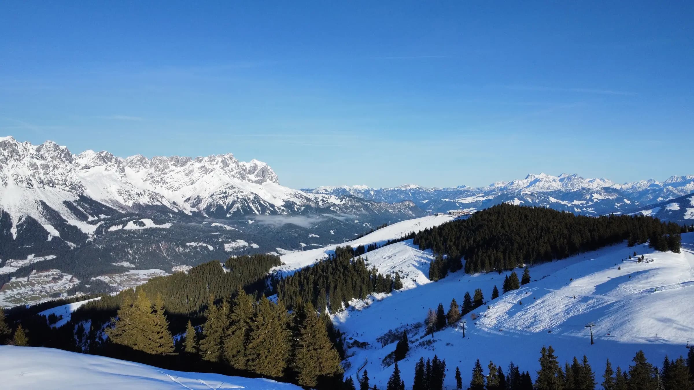 Stunning panorama of snow-covered Alps under a clear blue sky, perfect for winter inspiration.