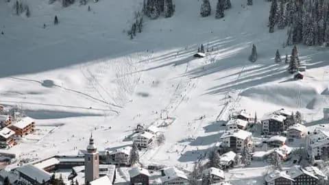 A beautiful aerial view of snowy ski slopes and village in Lech am Arlberg, Austria.