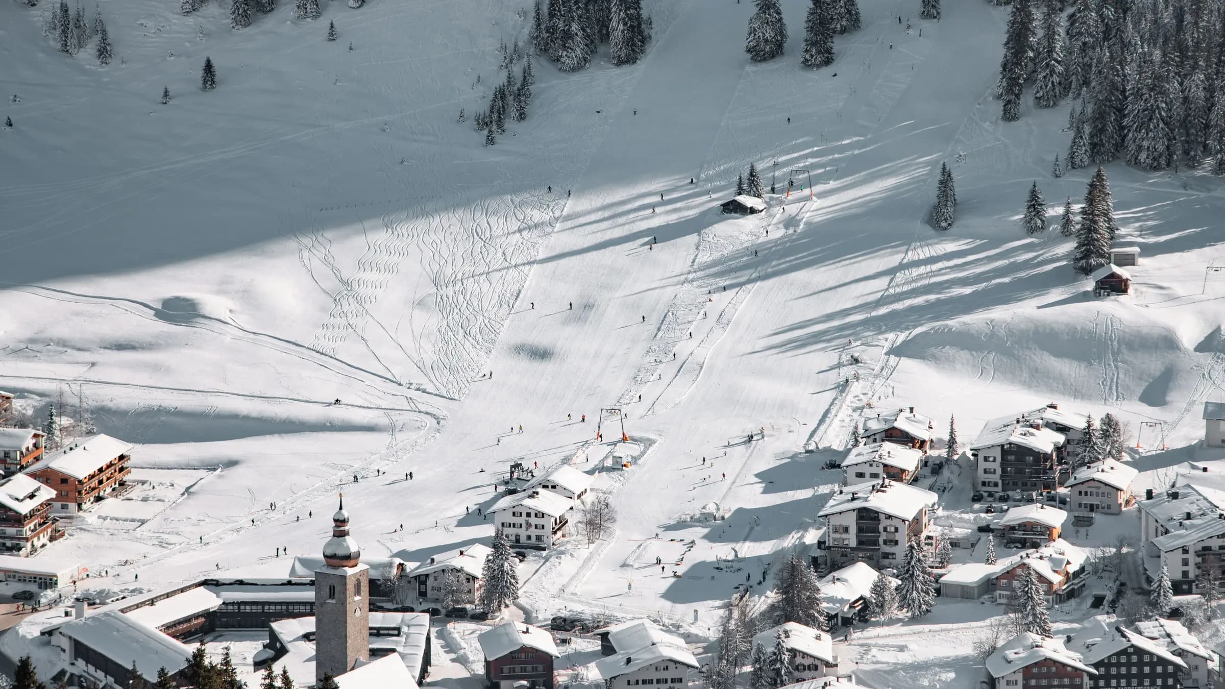 A beautiful aerial view of snowy ski slopes and village in Lech am Arlberg, Austria.
