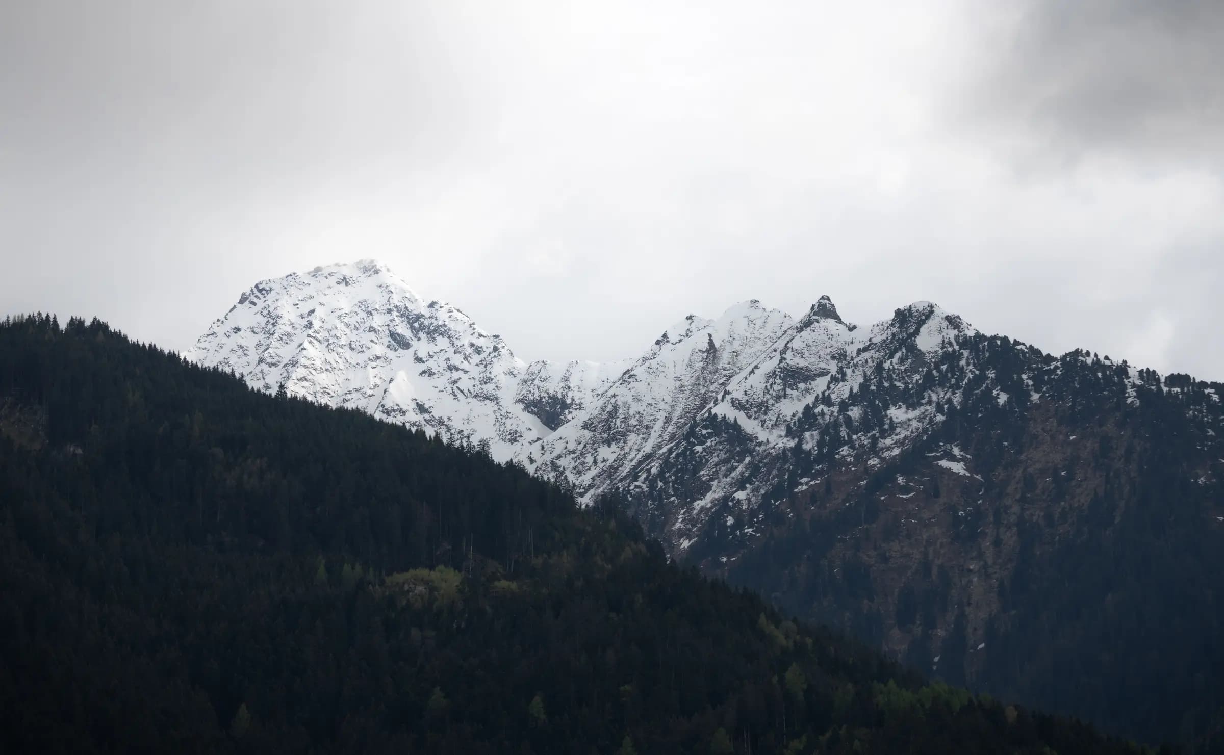 Stunning snowy mountain peaks in Tirol, Austria, offering a serene natural landscape.