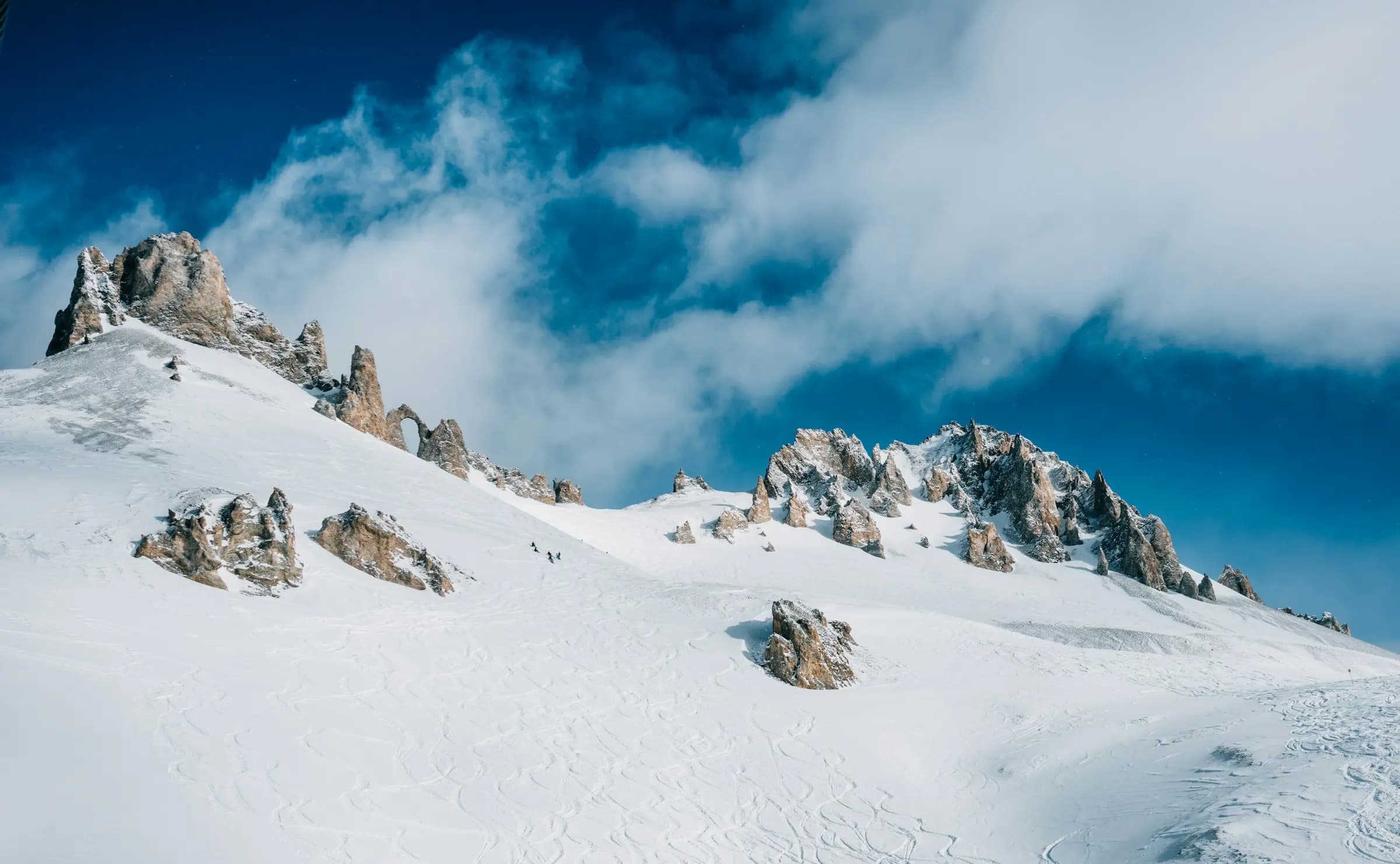 snow-covered rock mountain under clods