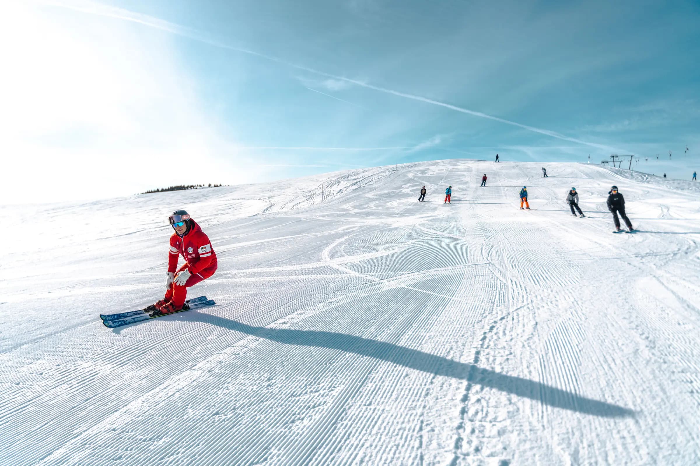 Skiers and snowboarders enjoying a sunny day on the slopes
