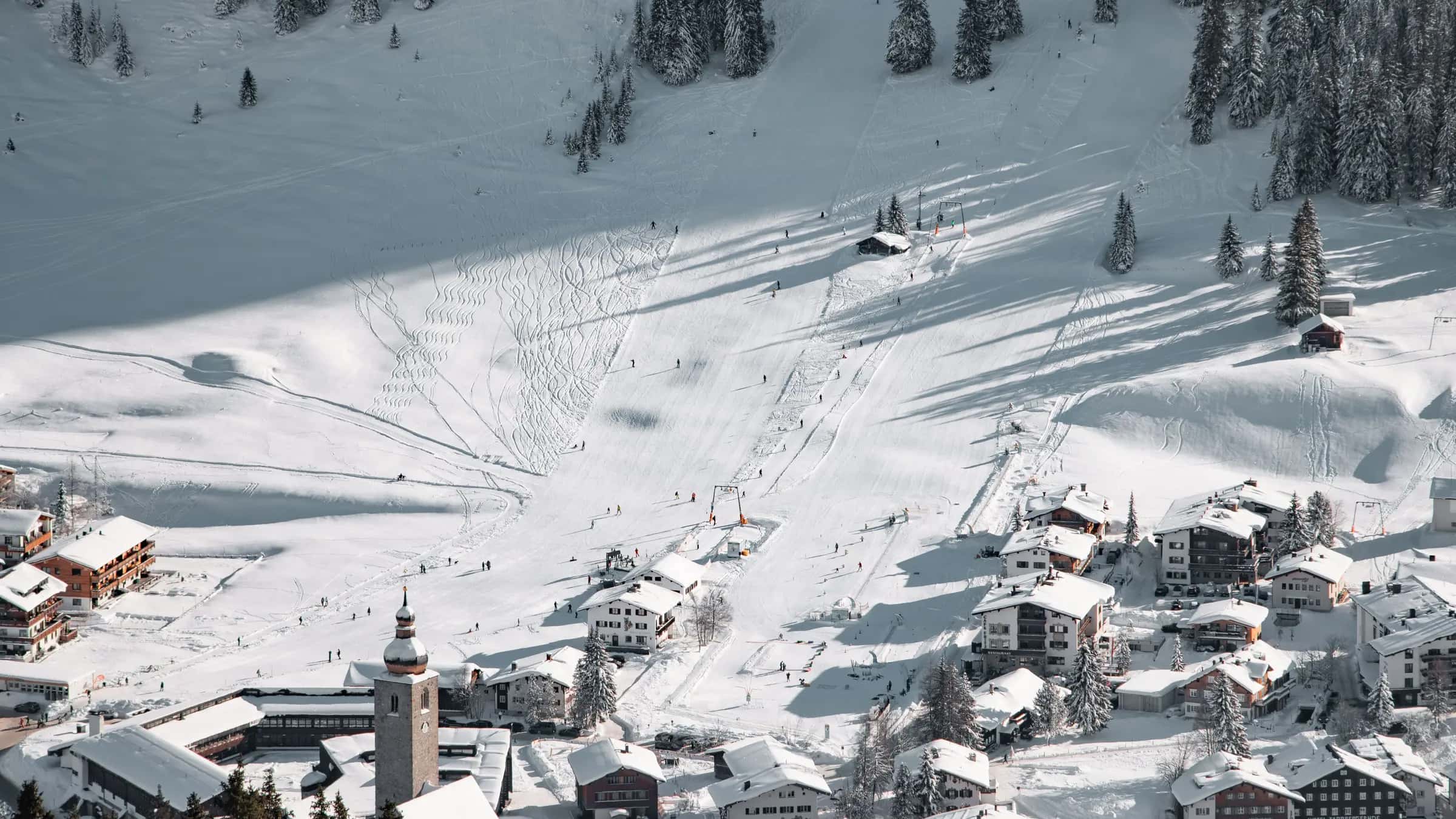 A beautiful aerial view of snowy ski slopes and village in Lech am Arlberg, Austria.