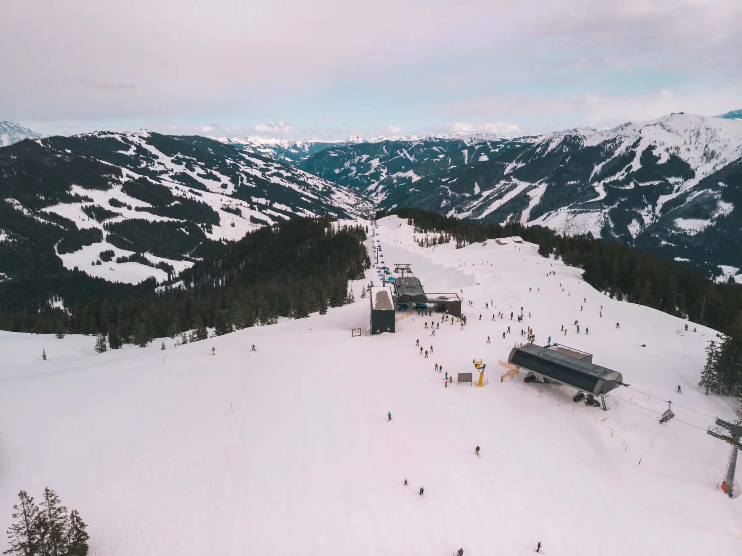 Breathtaking aerial shot of a snowy ski resort in the Austrian Alps, ideal for winter sports enthusiasts.
